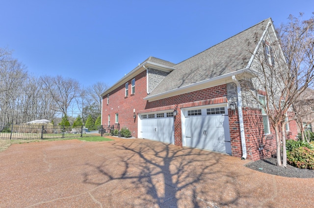 127 Waters Hill Cir, Lebanon, TN 37087 - view of side of home featuring driveway, fence, brick siding, and roof with shingles