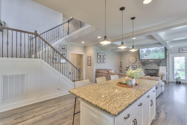 127 Waters Hill Cir, Lebanon, TN 37087 - kitchen featuring visible vents, wood finished floors, white cabinetry, and a fireplace