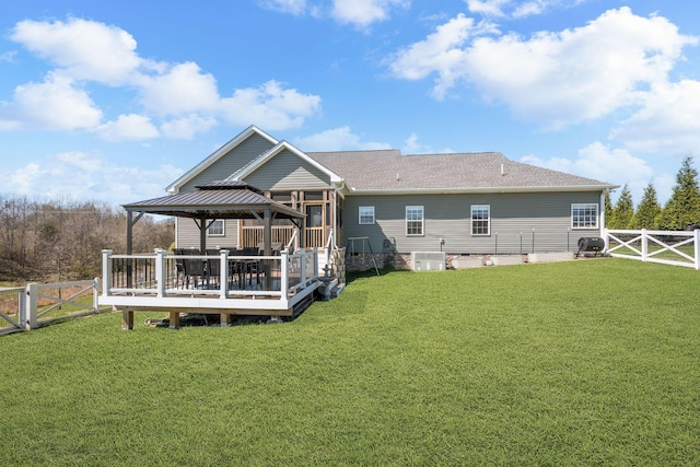 back of house with a gate, a fenced backyard, a gazebo, and a yard