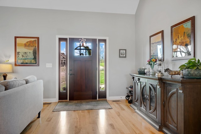 entrance foyer with baseboards and light wood-style floors
