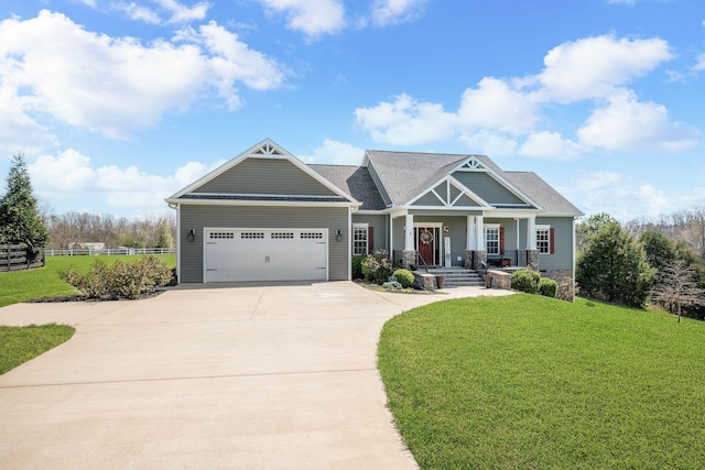 craftsman-style house with an attached garage, fence, a front lawn, and concrete driveway