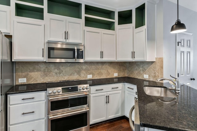 kitchen with a sink, open shelves, white cabinets, and appliances with stainless steel finishes