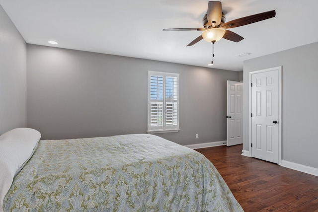 bedroom with visible vents, baseboards, a ceiling fan, and wood finished floors