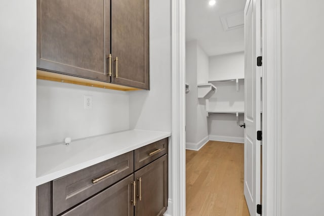 interior space featuring baseboards and light wood-style floors