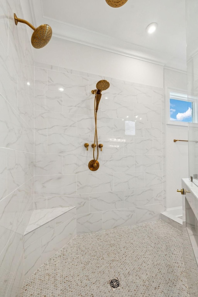 bathroom featuring tiled shower and crown molding