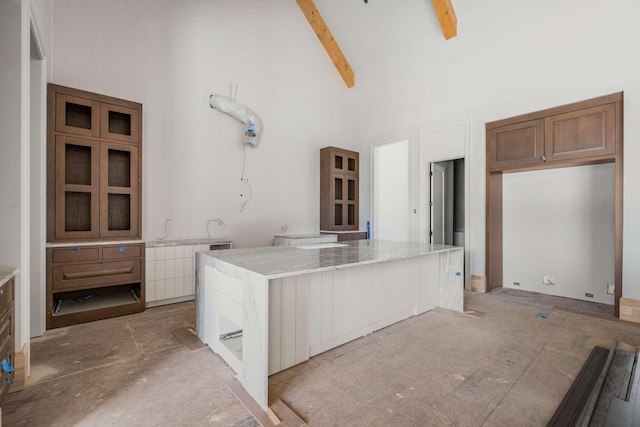 8115 Devens Dr, Brentwood, TN 37027 - kitchen featuring a kitchen island, high vaulted ceiling, beamed ceiling, and light stone counters