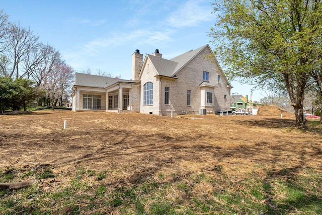 8115 Devens Dr, Brentwood, TN 37027 - back of property featuring a chimney, cooling unit, and brick siding
