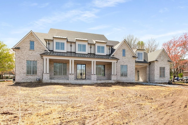 8115 Devens Dr, Brentwood, TN 37027 - view of front of home with metal roof, a standing seam roof, brick siding, and roof with shingles