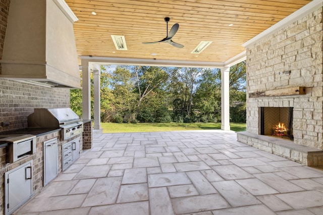 8115 Devens Dr, Brentwood, TN 37027 - view of patio / terrace with a grill, area for grilling, an outdoor stone fireplace, and a ceiling fan