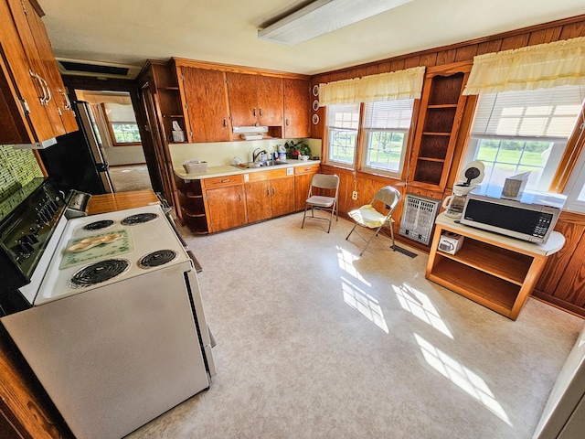 101 Church St, Wartrace, TN 37183 - kitchen with brown cabinetry, freestanding refrigerator, electric range, and a healthy amount of sunlight