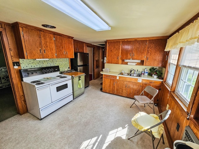 101 Church St, Wartrace, TN 37183 - kitchen featuring tasteful backsplash, light countertops, freestanding refrigerator, brown cabinetry, and electric stove