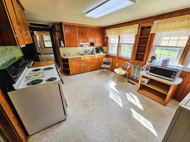 101 Church St, Wartrace, TN 37183 - kitchen with brown cabinets, appliances with stainless steel finishes, light countertops, and a healthy amount of sunlight