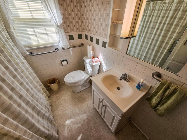101 Church St, Wartrace, TN 37183 - bathroom with vanity, wallpapered walls, toilet, wainscoting, and tile walls