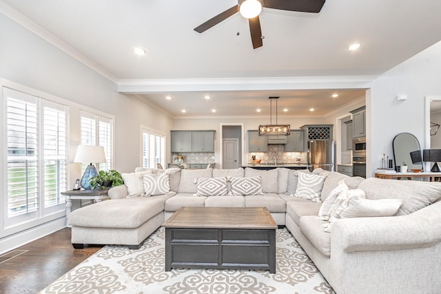 living area with recessed lighting, ornamental molding, ceiling fan with notable chandelier, and wood finished floors