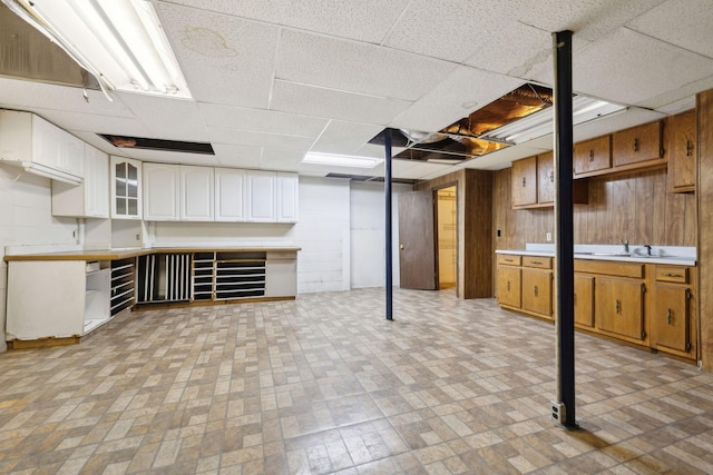 3755 Bear Hollow Rd, Joelton, TN 37080 - finished basement featuring a sink, wooden walls, and a paneled ceiling