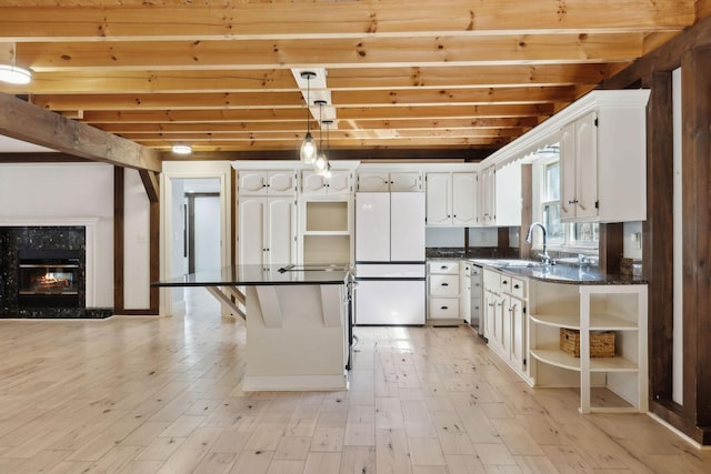 3755 Bear Hollow Rd, Joelton, TN 37080 - kitchen featuring open shelves, light wood-type flooring, dark countertops, freestanding refrigerator, and white cabinets