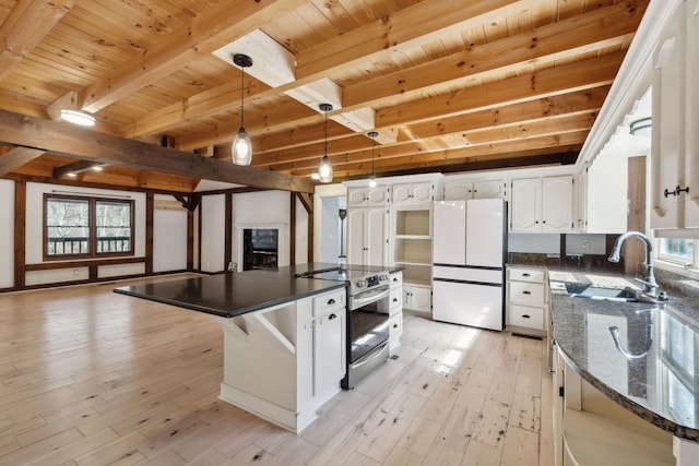 3755 Bear Hollow Rd, Joelton, TN 37080 - kitchen featuring stainless steel range with electric stovetop, light wood finished floors, a sink, wooden ceiling, and freestanding refrigerator