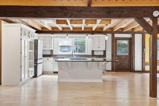 3755 Bear Hollow Rd, Joelton, TN 37080 - kitchen with white cabinetry, beam ceiling, and a wealth of natural light