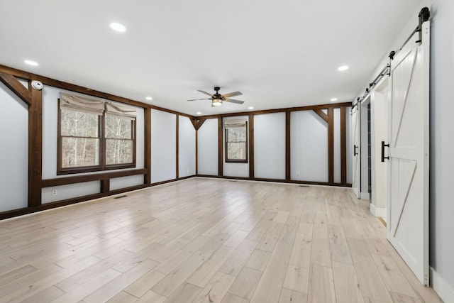 3755 Bear Hollow Rd, Joelton, TN 37080 - spare room featuring a ceiling fan, a barn door, light wood-type flooring, visible vents, and recessed lighting