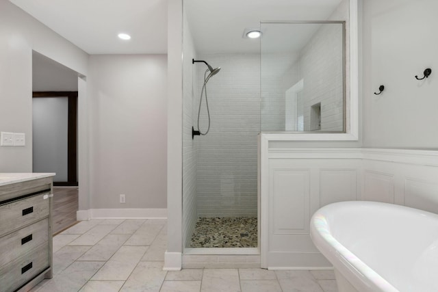 3755 Bear Hollow Rd, Joelton, TN 37080 - full bathroom with a soaking tub, baseboards, marble finish floor, vanity, and tiled shower