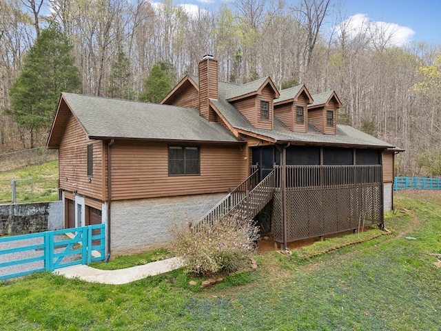 3755 Bear Hollow Rd, Joelton, TN 37080 - back of property with a chimney, a sunroom, fence, a garage, and a lawn