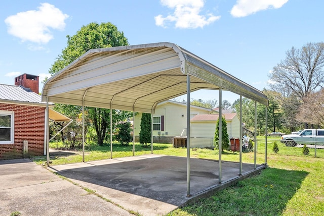 view of parking / parking lot featuring a detached carport and fence