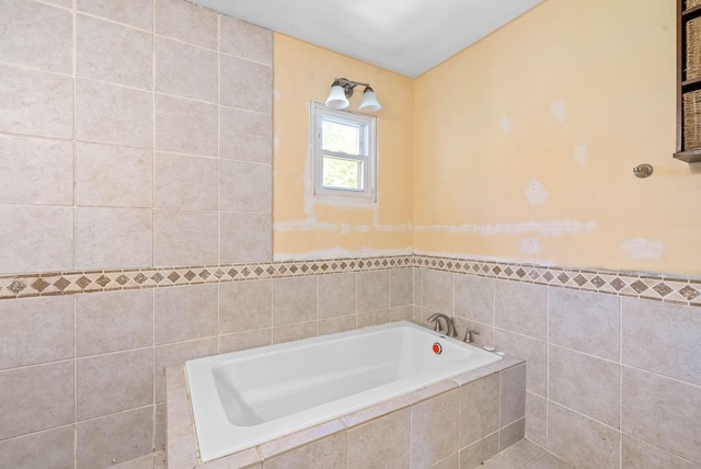 full bathroom featuring a bath and tile walls