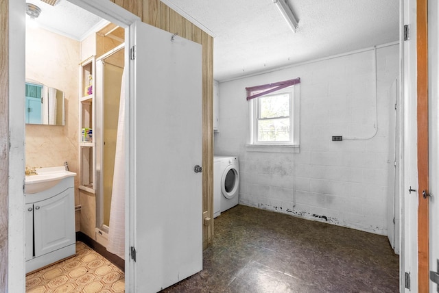 laundry room featuring washer / dryer, ornamental molding, a textured ceiling, and laundry area