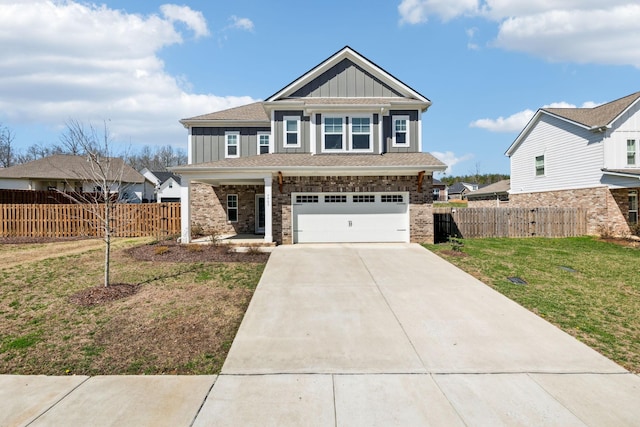 7403 Hemen Way, Fairview, TN 37062 - view of front of property with concrete driveway, an attached garage, fence, board and batten siding, and a front lawn