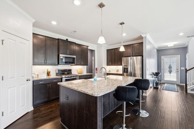 7403 Hemen Way, Fairview, TN 37062 - kitchen featuring light stone counters, dark brown cabinetry, a sink, appliances with stainless steel finishes, and dark wood-style flooring