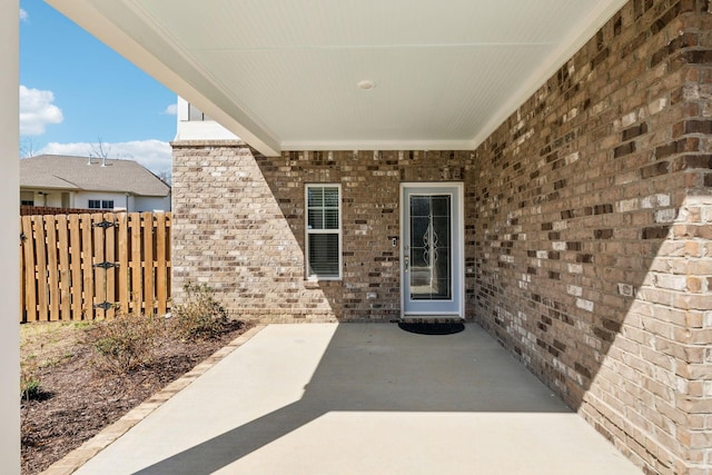 7403 Hemen Way, Fairview, TN 37062 - property entrance featuring a patio, brick siding, and fence