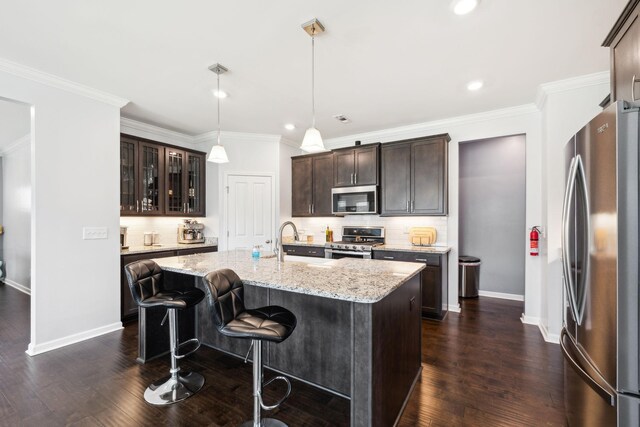 7403 Hemen Way, Fairview, TN 37062 - kitchen featuring dark wood finished floors, dark brown cabinetry, decorative backsplash, and appliances with stainless steel finishes