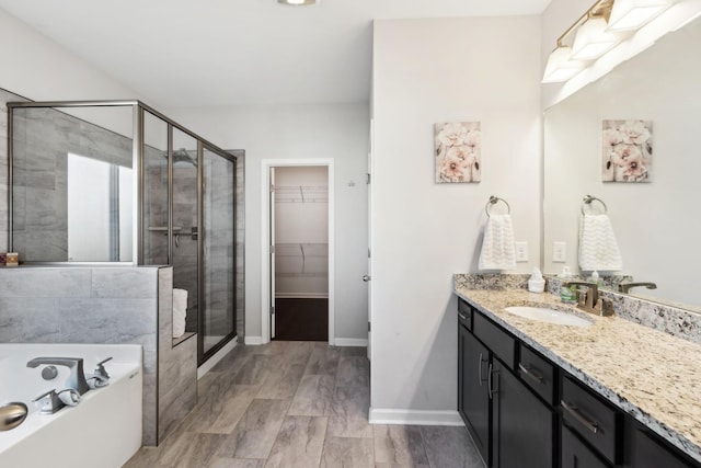 7403 Hemen Way, Fairview, TN 37062 - full bathroom featuring a bath, a shower stall, baseboards, vanity, and a walk in closet