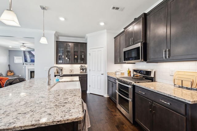 7403 Hemen Way, Fairview, TN 37062 - kitchen featuring visible vents, crown molding, light stone countertops, stainless steel appliances, and a sink