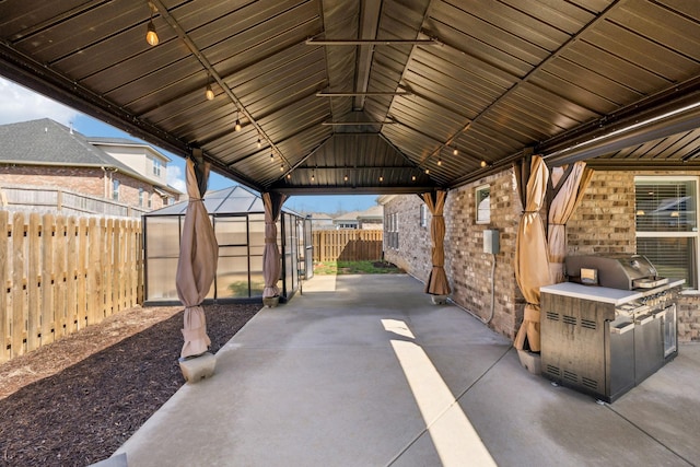 7403 Hemen Way, Fairview, TN 37062 - view of patio with an outdoor structure, a fenced backyard, and an outdoor kitchen