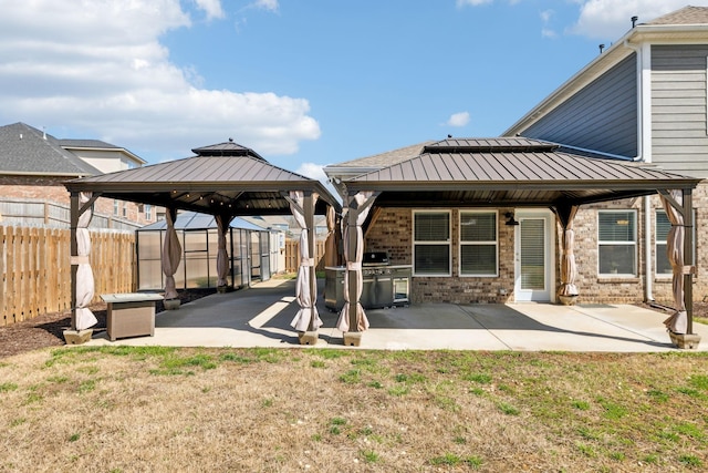 7403 Hemen Way, Fairview, TN 37062 - back of house with a fenced backyard, a standing seam roof, a gazebo, and a patio area