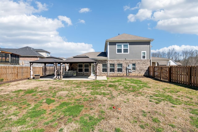 7403 Hemen Way, Fairview, TN 37062 - back of property with a fenced backyard, a gazebo, brick siding, a lawn, and a patio area