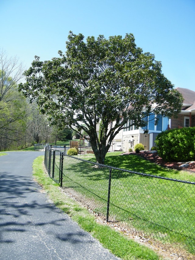 exterior space featuring a front yard and fence