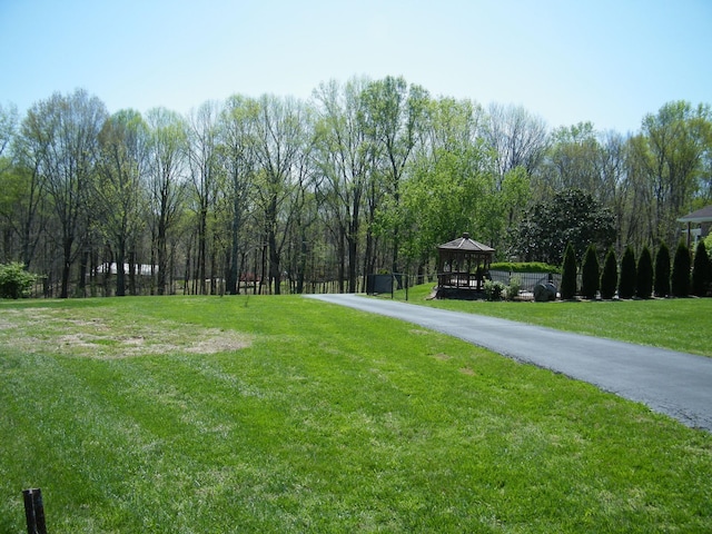 view of property's community with a yard and a gazebo