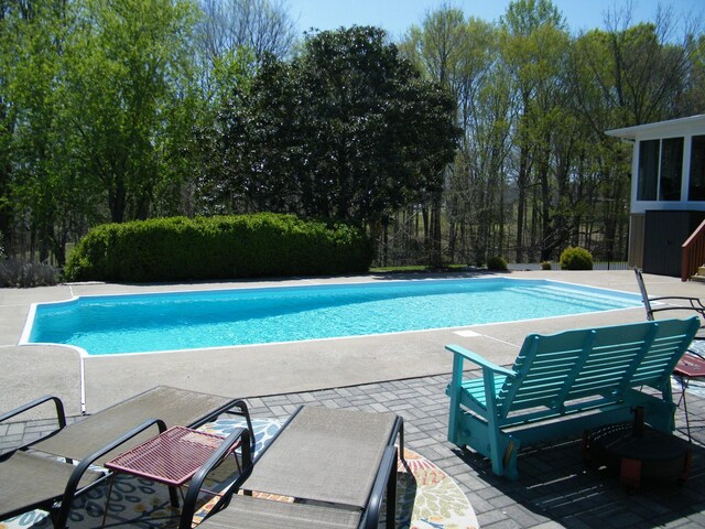 outdoor pool featuring a patio area