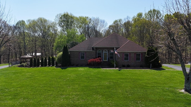 view of front of home with a front yard and brick siding