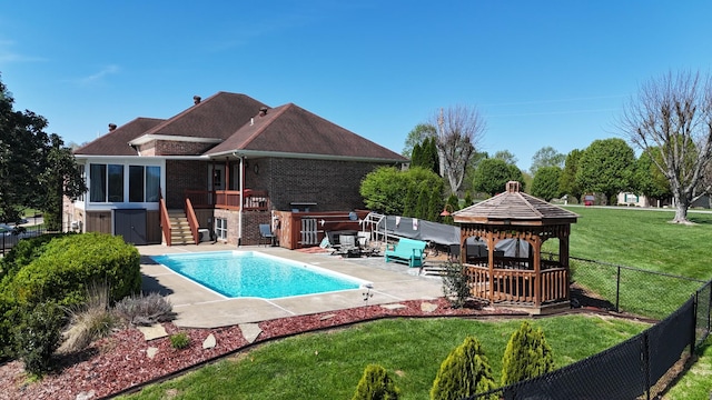 view of pool with a yard, a patio area, stairs, a gazebo, and fence