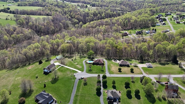 birds eye view of property featuring a view of trees