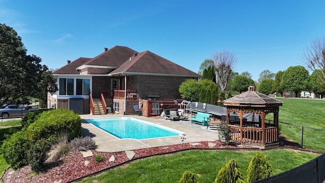 view of swimming pool with a yard, a gazebo, fence, a patio, and a fenced in pool