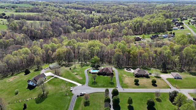 birds eye view of property featuring a wooded view