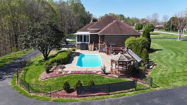 view of swimming pool featuring a patio, a yard, a fenced in pool, and fence private yard