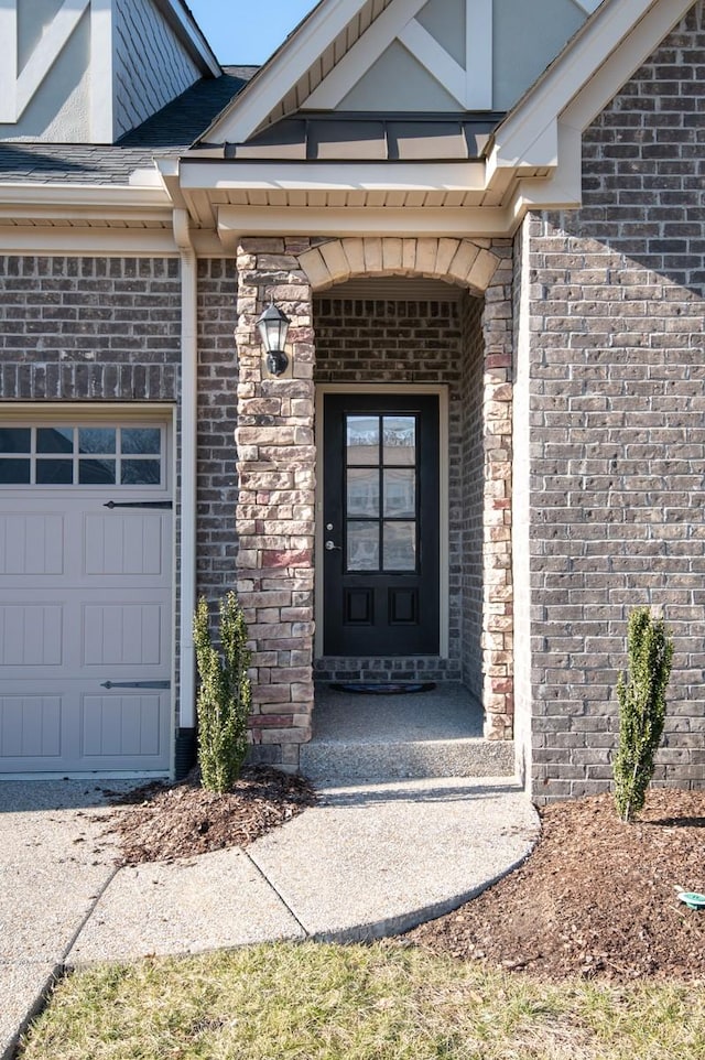 124 Day Star Ct, Gallatin, TN 37066 - view of exterior entry featuring brick siding and a garage