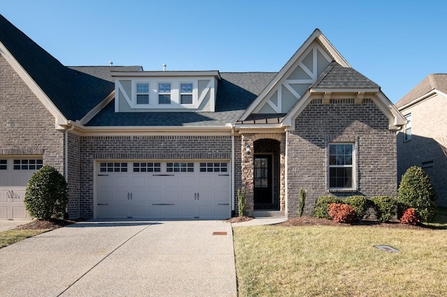 124 Day Star Ct, Gallatin, TN 37066 - view of front of home with roof with shingles, an attached garage, driveway, a front lawn, and brick siding