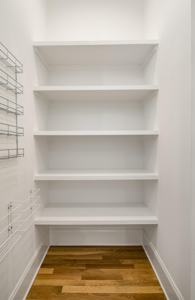 interior details featuring wood finished floors and baseboards