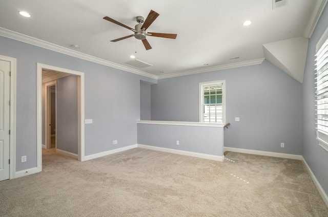 carpeted spare room featuring a ceiling fan, baseboards, and crown molding
